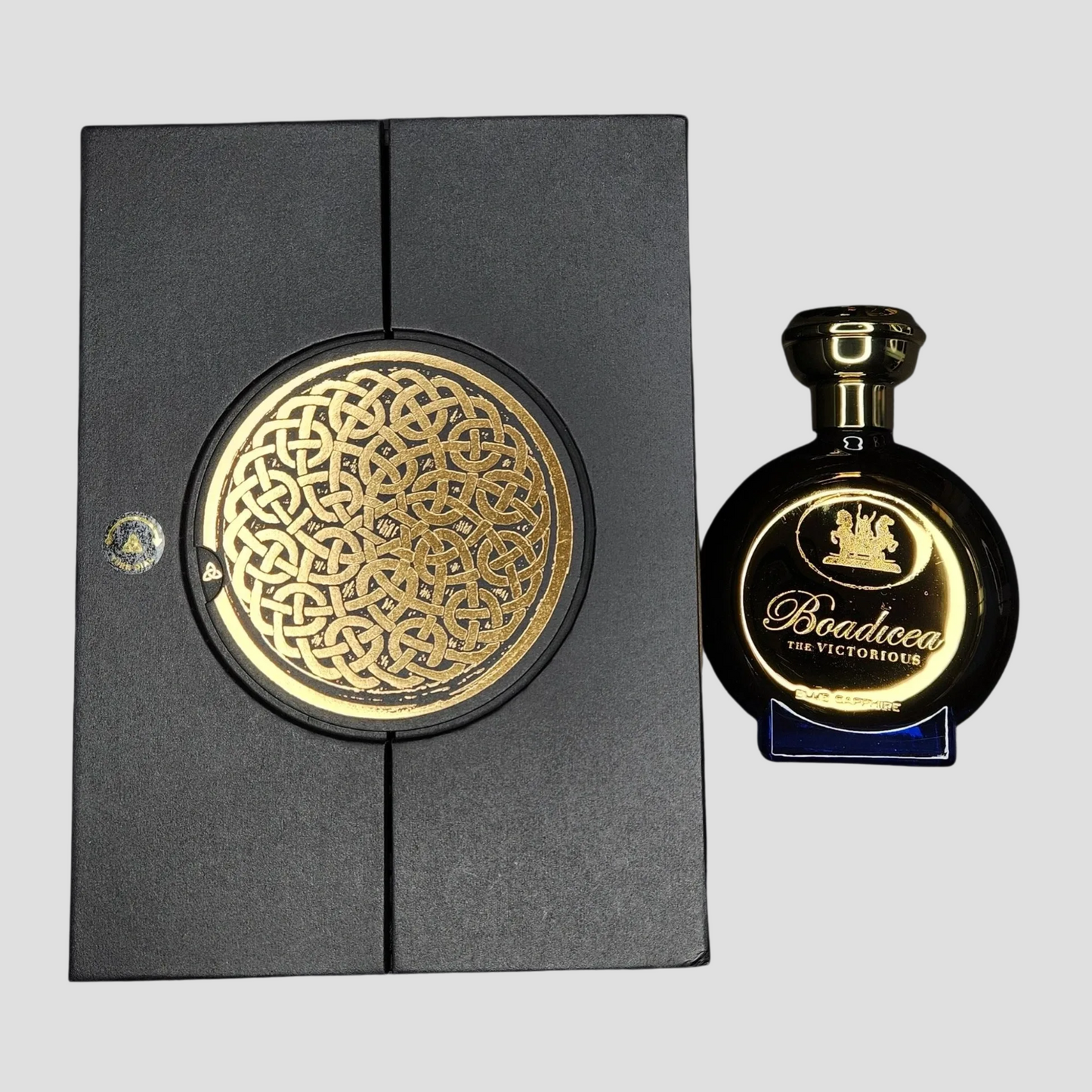Boadicea the Victorious perfume bottle with decorative packaging on a light gray background